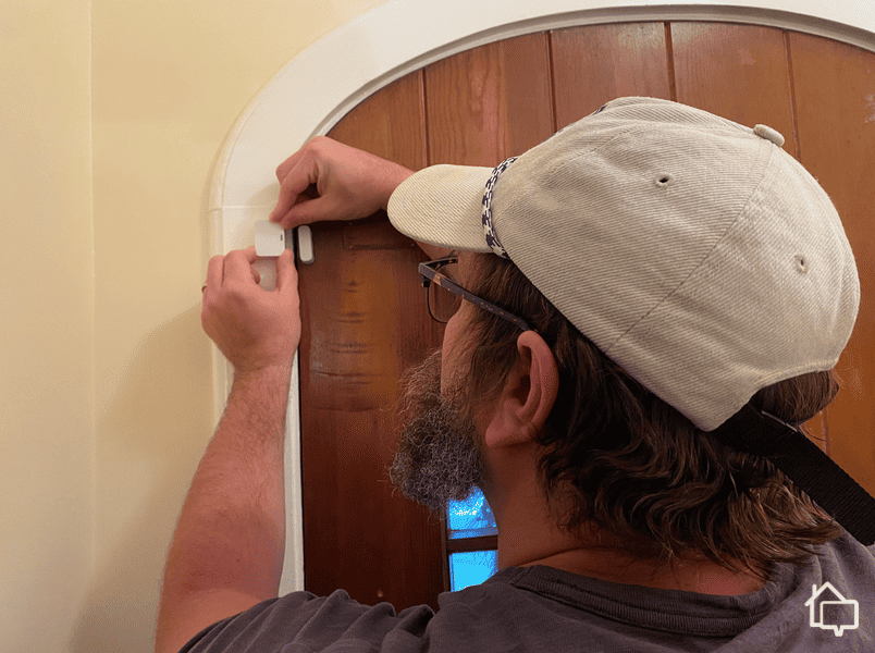 Installing a SimpliSafe entryway sensor.